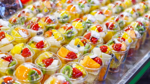 small cups filled with fruit on table